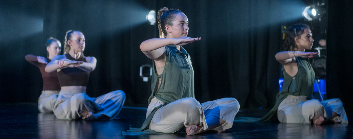 Students performing a routine on stage