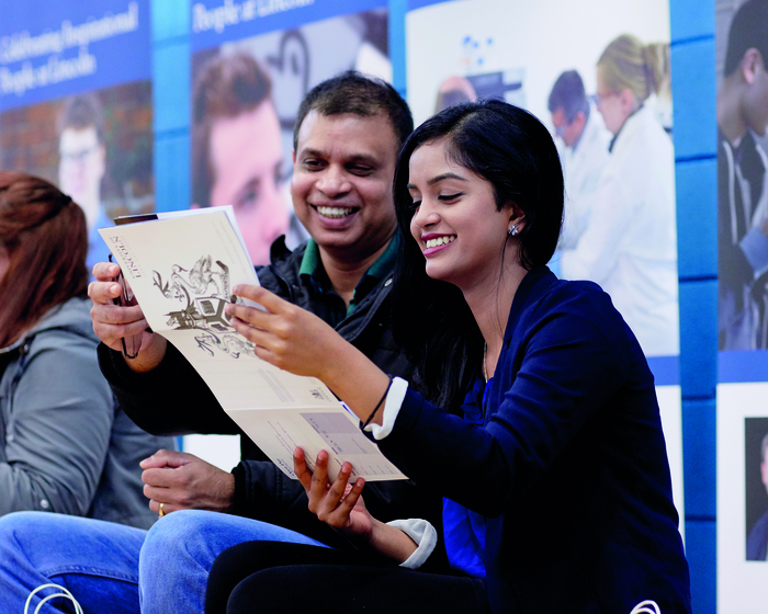 Parent sitting with their child at a Lincoln Open Day.