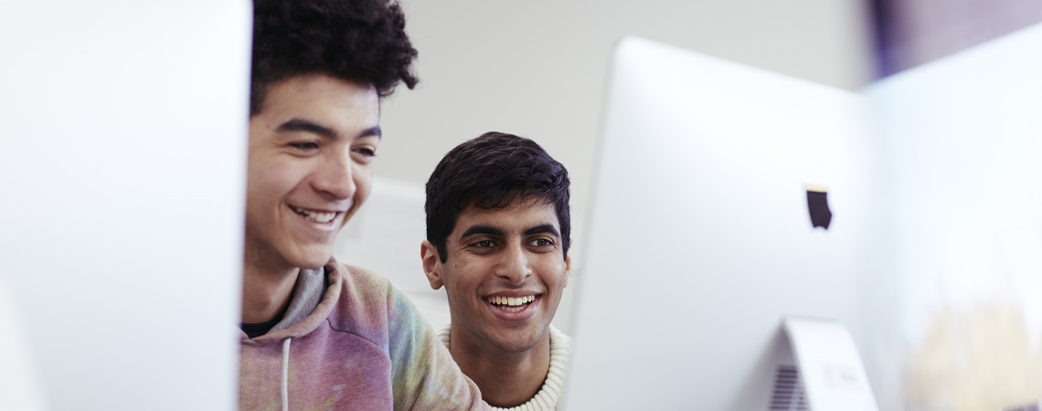 Students working on a Mac