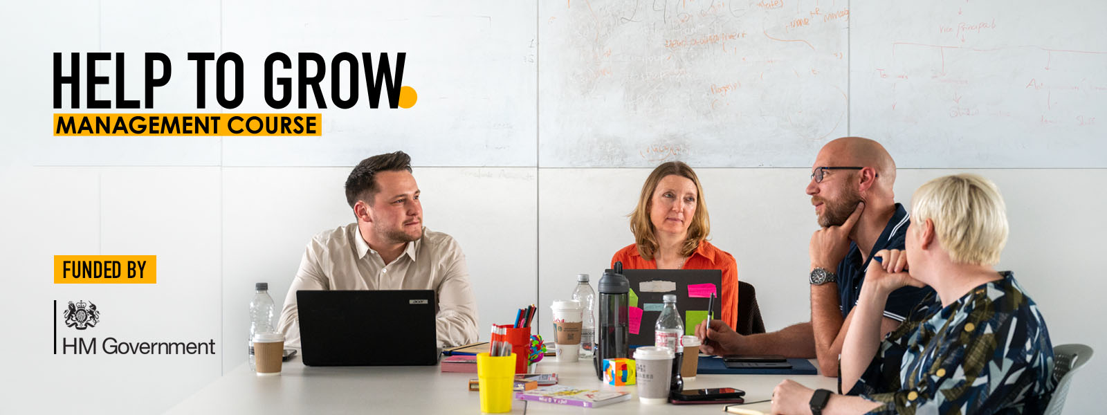 A group of business professionals sat talking around a table