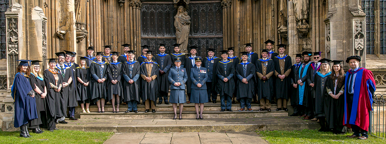 Armed Forces graduates posing for a photo in front of Lincoln Cathedral